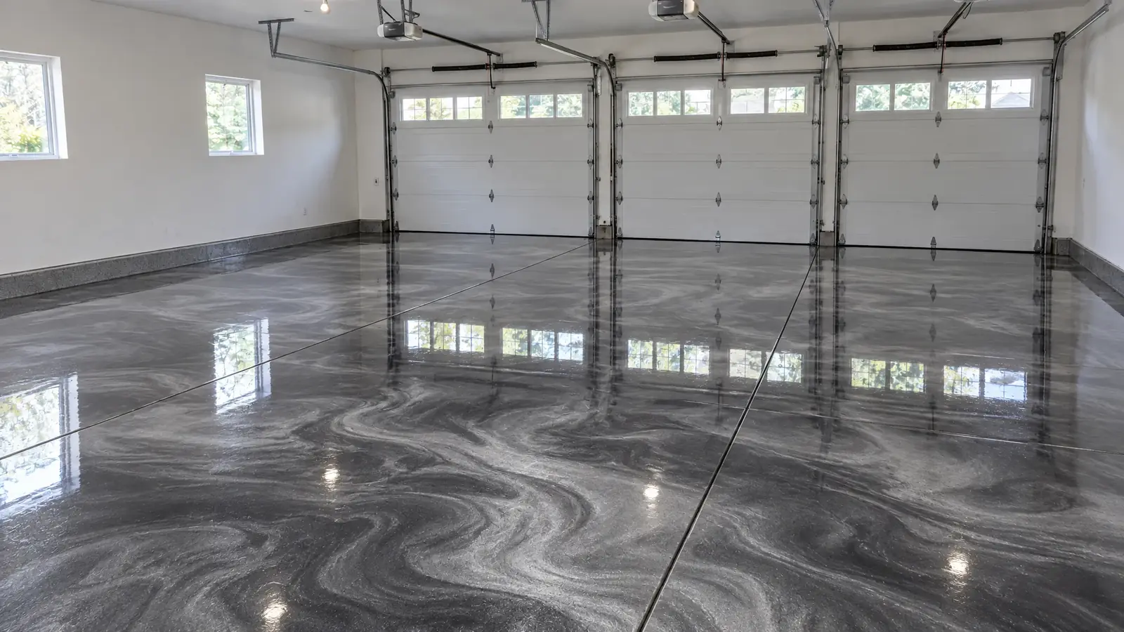 The same three-car garage after installing a metallic charcoal floor